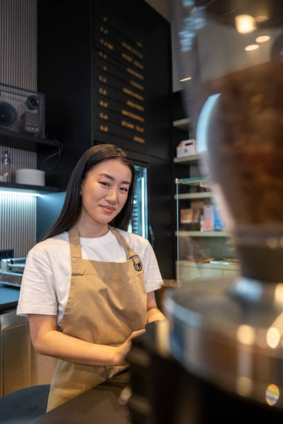 istock Contented cafe barista posing for the camera in the workplace 1482248518