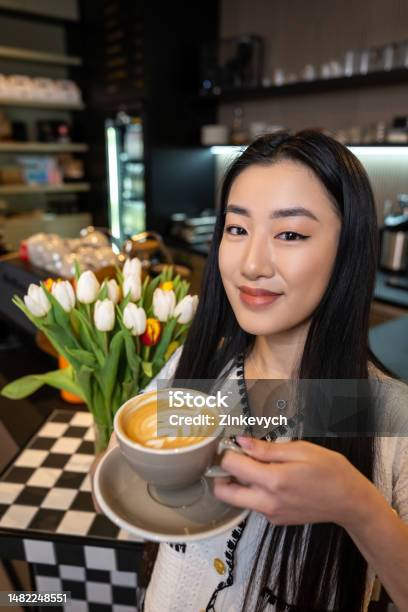 Smiling Coffeehouse Visitor With A Caffeinated Drink In Her Hand Stock Photo - Download Image Now