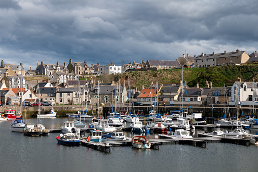 5 April 2023. Findochty Harbour,Moray,Scotland. This is the Harbour and Marina area of the Moray Coast Fishing Harbour with a stormy sky and clouds forming but the sun still shining.