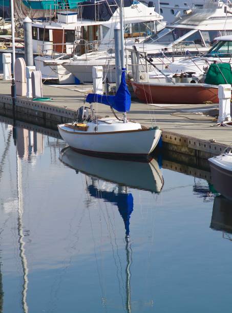 Focus on a small sailboat in the marina