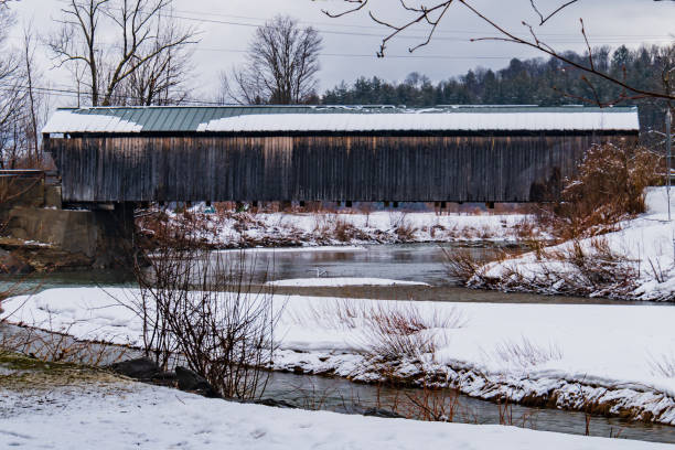 istock historic covered bridge crosses a river in rural Vermont 1482250629