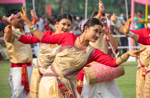 Guwahati, India. 14 April 2023. Young women in traditional Mekhela Chadar perform Bihu  dance, in a field in Guwahati, Assam, India on 14 April 2023.