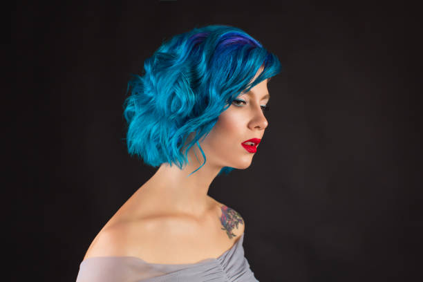 istock Girl with blue dyed hair in studio on black background 1482255128