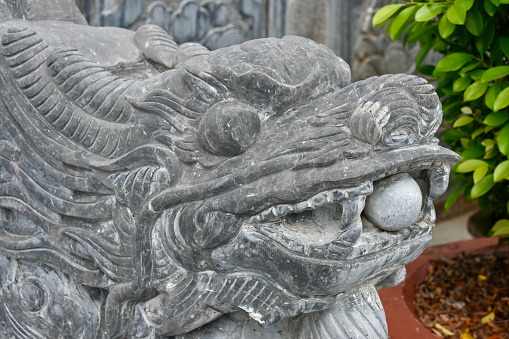 Dragon with ball sculpted into railing at Vietnamese Buddhist temple