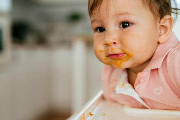 istock Messy Baby Girl Eating By Her Self 1482256159