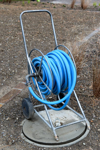 istock A long blue hose reel in a garden area. 1482256469