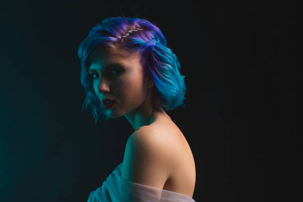 istock Girl with blue dyed hair in studio on black background 1482259214