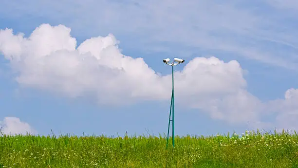 security videocamera on green field and grass