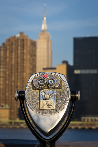 Coin operated electronic binoculars for tourists on a blurred mountain landscape
