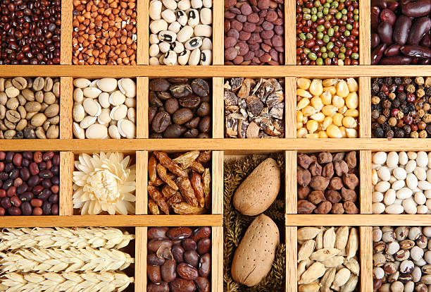 Spices and Seeds Background Collection of dried Indian spices, beans, grains and seeds in a wooden frame, suitable as background. spice rack stock pictures, royalty-free photos & images