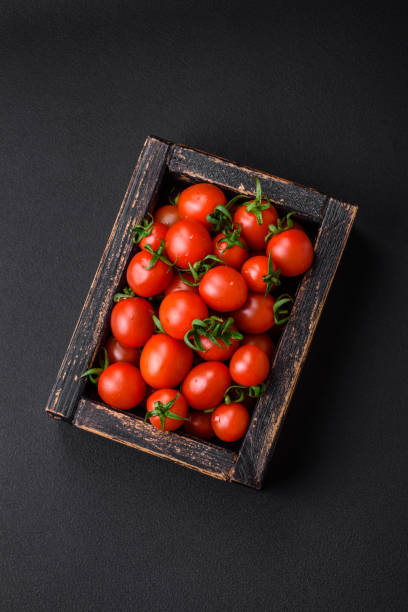 istock Fresh red cherry tomatoes in a wooden vintage box 1482268698