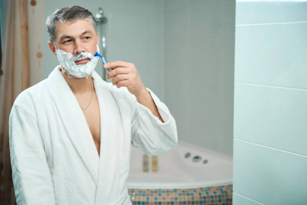 istock Man shaving in shower in the hostel 1482268751