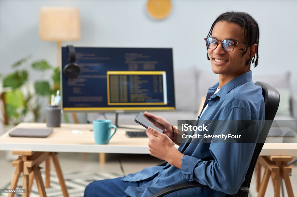 smiling software developer typing machine learning app... Smiling Computer Programmer Holding Tablet And Writing Code At ...