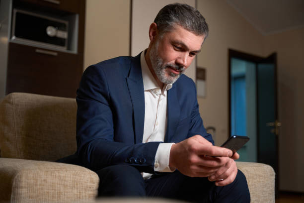 istock Adult man using phone in the motel 1482270867