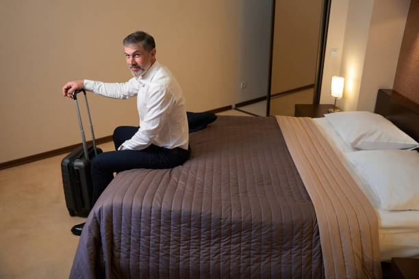istock Smiling man sitting on sofa in the hotel 1482270911