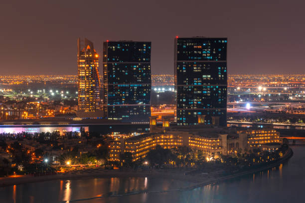Night sea view of the brightly lit Internet City area in Dubai. Concept of real estate investment and the cost of electricity for lighting