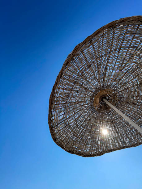 Beach umbrella against blue morning sky