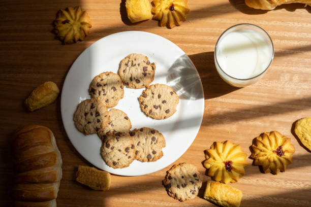 table served and ready with homemade cookies, bread and glass of milk, food and drink ready to eat - carbohydrate freshness food and drink studio shot imagens e fotografias de stock