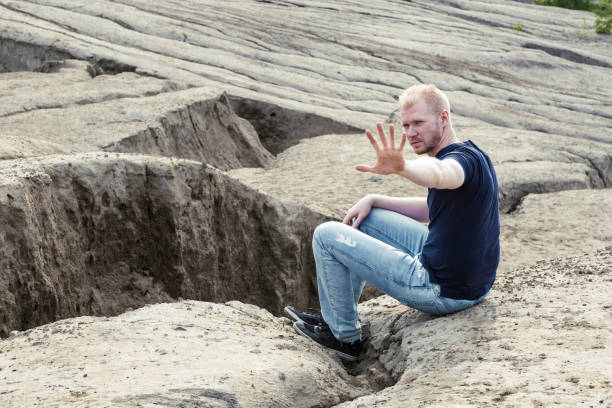 A man surrounded by mountains. Thoughtfulness and loneliness
