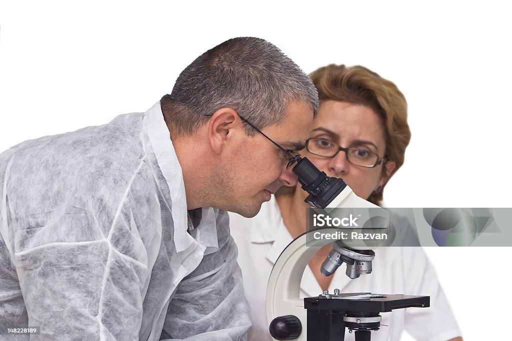 Researchers Two researchers working together with a microscope. Activity Stock Photo