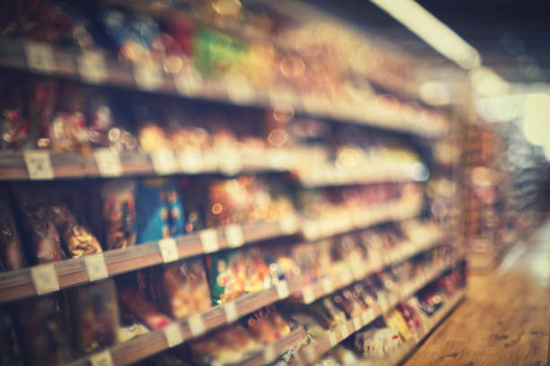 The shelves are full of products and the aisles of the market. supermarket mall convenience store Blurry background image