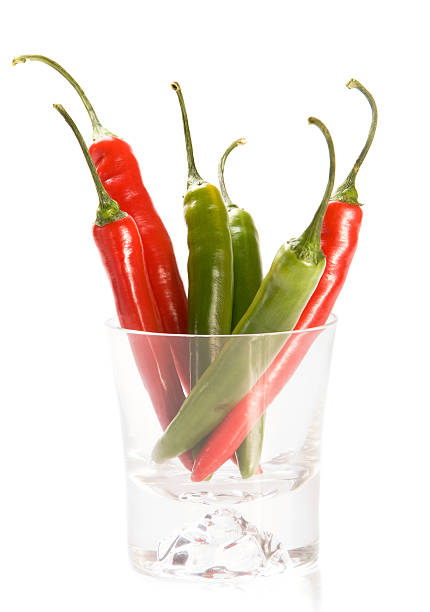 Red and green  chilly peppers in glass stock photo