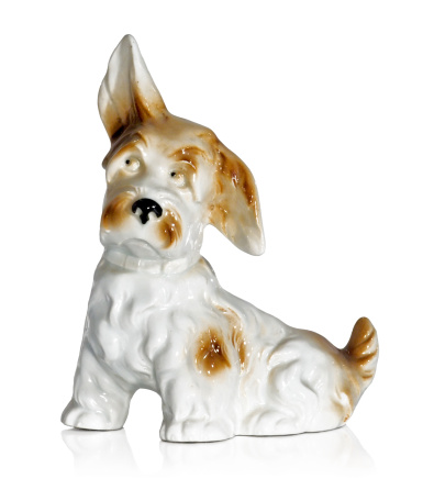 Old-fashioned figurine of a dog isolated on white