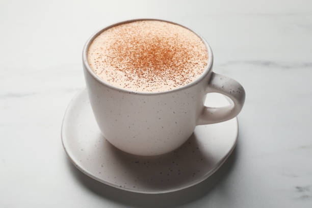 istock Delicious eggnog with cinnamon on white marble table, closeup 1482285593