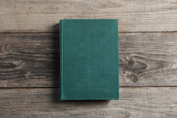 istock Old hardcover book on grey wooden table, top view 1482285964