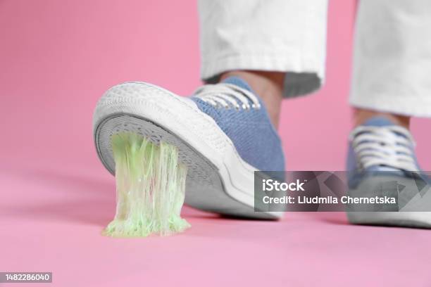 Person Stepping Into Chewing Gum On Pink Background Closeup Stock Photo - Download Image Now