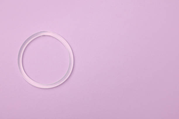 Diaphragm vaginal contraceptive ring on lilac background, top view. Space for text Diaphragm vaginal contraceptive ring on lilac background, top view. Space for text diaphragm contraceptive stock pictures, royalty-free photos & images