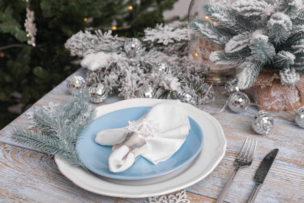 istock Festive place setting with beautiful dishware, cutlery and fabric napkin for Christmas dinner on light blue wooden table 1482286822