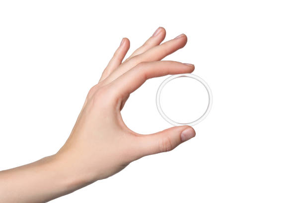 Woman holding diaphragm vaginal contraceptive ring on white background, closeup Woman holding diaphragm vaginal contraceptive ring on white background, closeup diaphragm contraceptive stock pictures, royalty-free photos & images