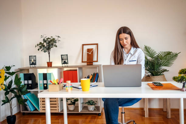 istock Young businesswoman working in office using laptop 1482286983