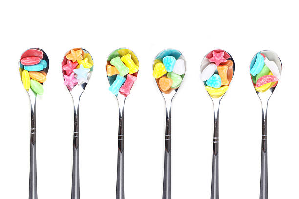istock Colorful candy with  metal spoons 148228771