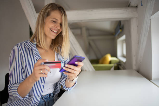 istock Cheerful  woman doing online shopping 1482289424