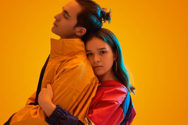 istock Stylish couple embracing in studio with neon lights 1482291130