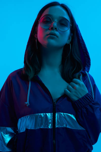 istock Stylish young female under blue neon light 1482291161