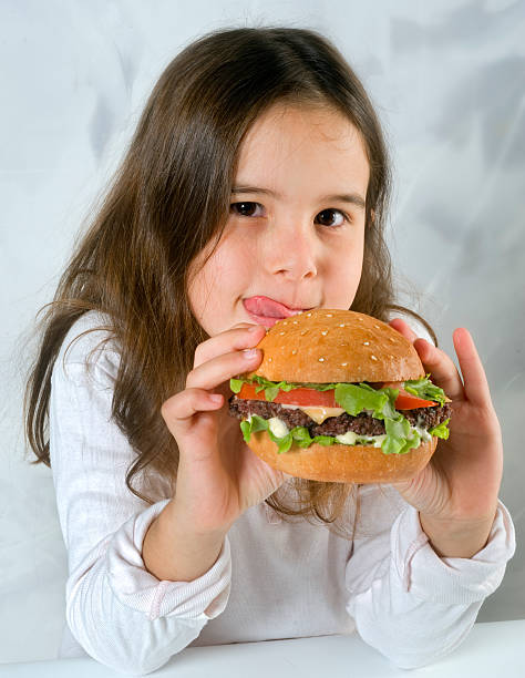 istock girl eating hamburger 148229319