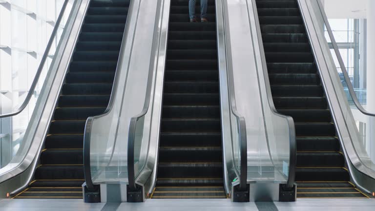 business people on escalators in busy corporate office lobby working nine to five rush 4k footage