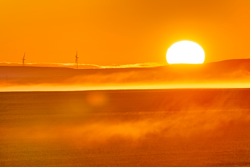 Sunrise over a wind farm in rural Alberta Canada