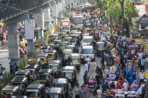 Mumbai, India - 26 March 2023, Traffic jam on a busy street, market. Shopping, pollution, vehicles, carbon mono-oxide, auto rickshaw, festival, transportation, police, people, road, city, urbanization