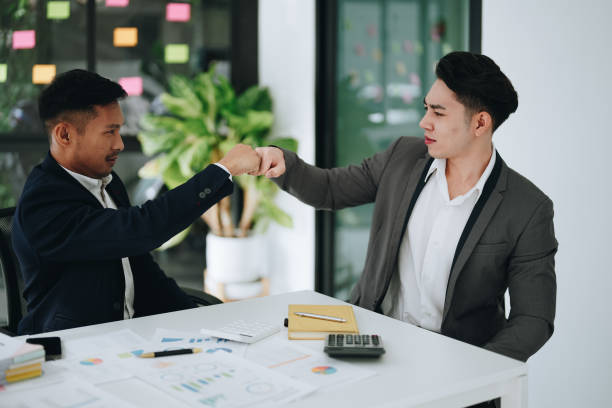 istock Give me five. managers employees join hands high celebrate common achievement. Two young men successful teammates friends greet each other with great job result 1482307702