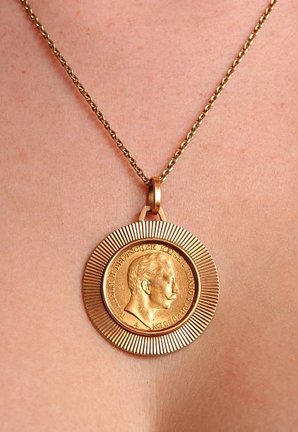 Necklace with old gold coin. stock photo