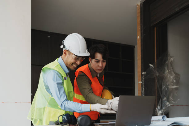istock multi ethnic engineer brainstorming and measuring for cost estimating on blueprint and floor plan drawings about design architectural and engineering for houses and buildings 1482310400