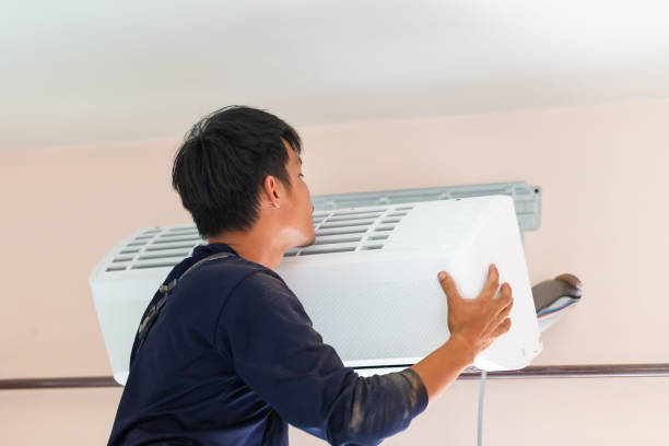 istock Electrician installing air conditioner unit, Technician man installing an air conditioning in a client house, Repairman fixing air conditioner unit, Maintenance and repairing concepts 1482316438