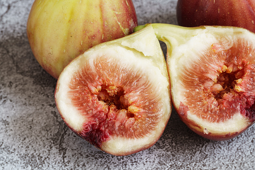 Fresh figs in different grade, vintage wooden Board.selective focus