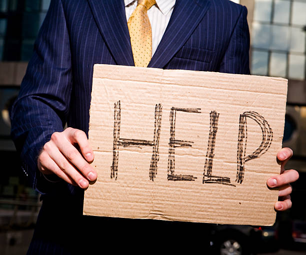 istock Businessman holding sign Help outdoors 148231708