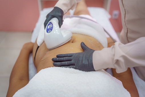 Esthetician applying combined therapy with ultrasound. Dermatology and aesthetic consultation.