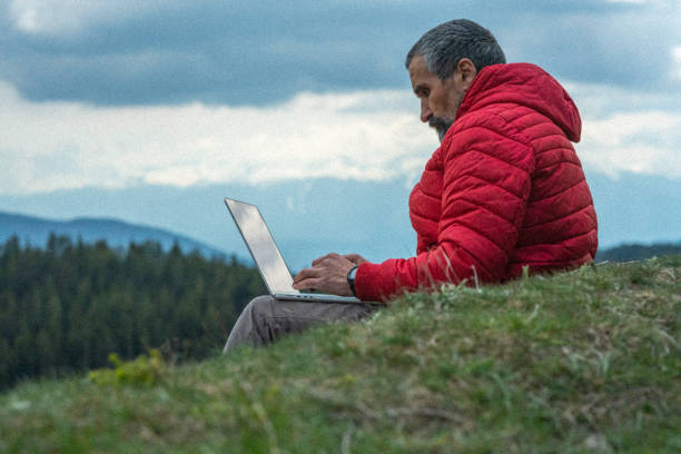 istock People and nature.  Man with laptop in nature. 1482323414